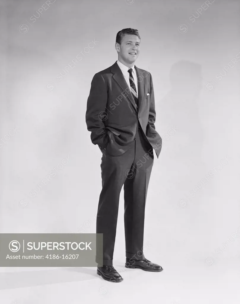 1950S 1960S Portrait Smiling Man Standing With Hands In Pockets Wearing Suit And Tie