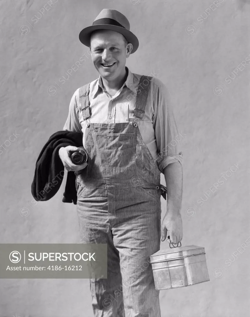 1930S Smiling Man In Work Clothes Overalls Holding Lunch Box Thermos Bottle And Sweater