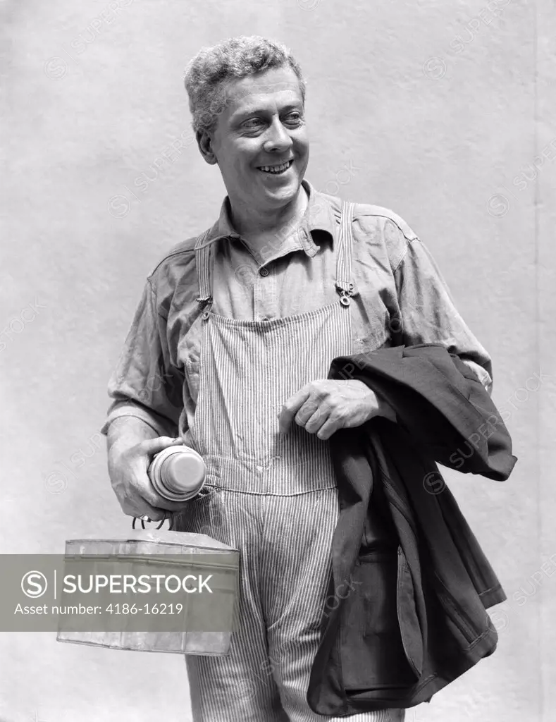 1930S Man In Overalls Work Uniform Holding Thermos Lunchbox And Jacket