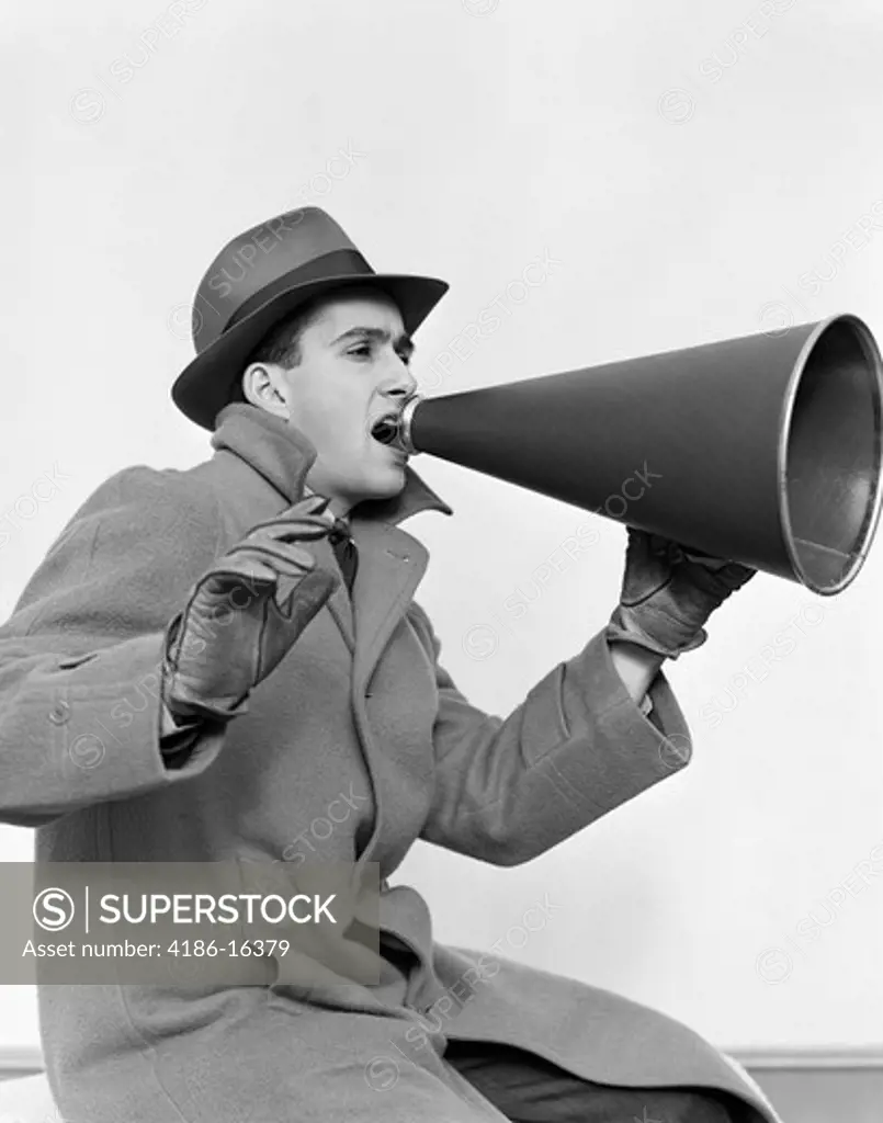 1940S Man In Coat Hat And Gloves Yelling In Megaphone
