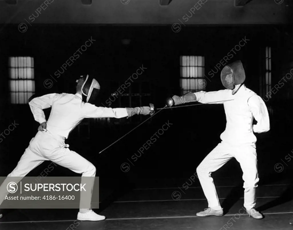 1940S 1950S Two Fencers Fencing Both Are Wearing White Uniforms And Face Masks Both Left Hands