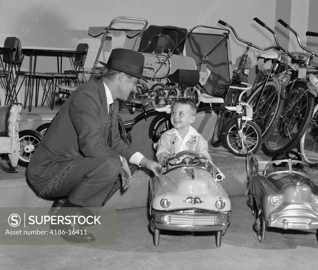 1950S Father In Toy Store With Son Driving Toy Convertible
