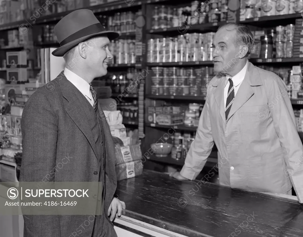 193Os Two Men Talking In General Store Over Counter