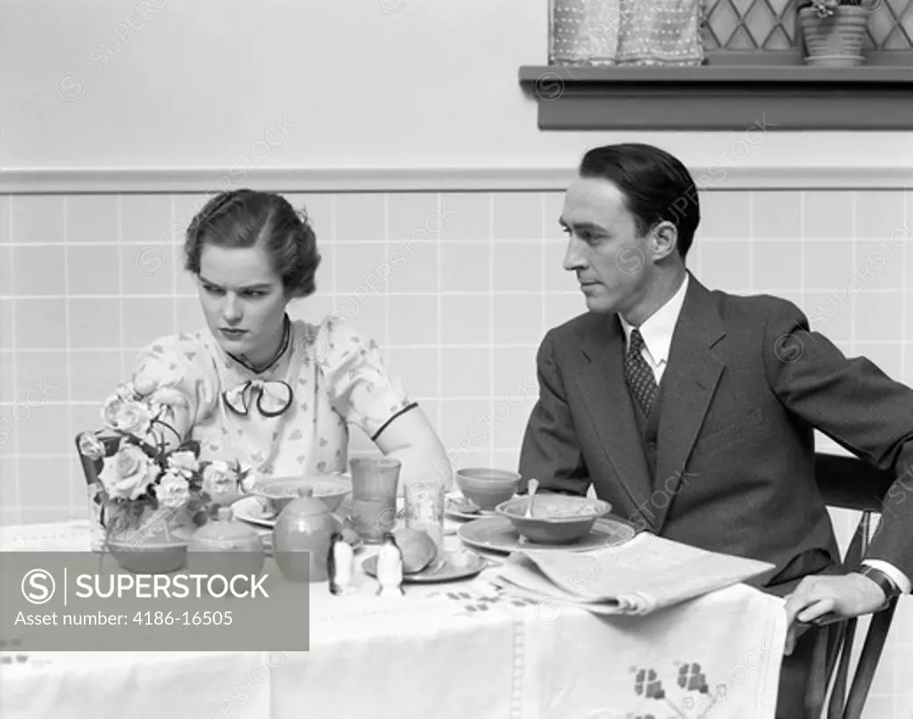 1930S Quarreling Couple At A Table Set For Breakfast The Woman Is Wearing Print Dress Bow