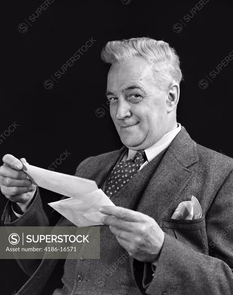 1940S Man In Suit Holding Opened Mail Letter