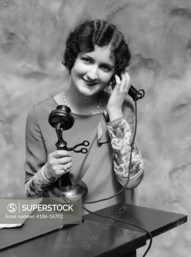 1920S Portrait Of Woman On Candlestick Telephone Smiling At Camera
