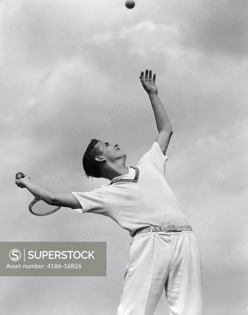 1930S 1940S Boy Tennis Player Throwing Ball In Air For A Serve With Tennis Racket In Hand