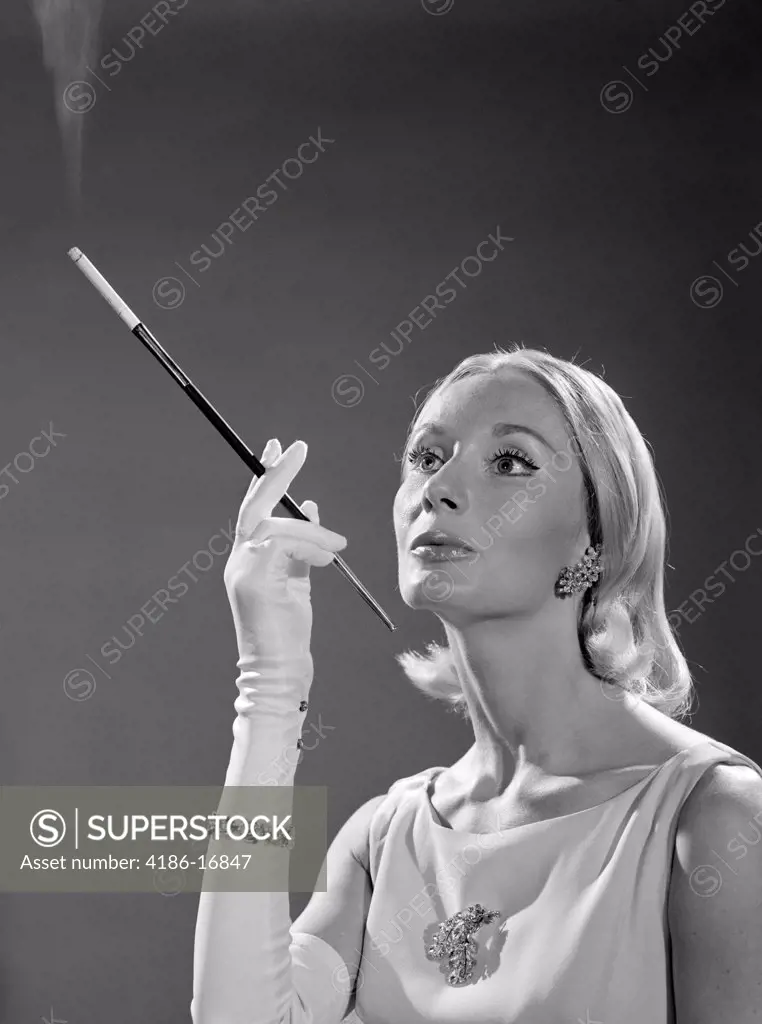 1960S Portrait Of Elegant Blonde Woman Wearing Gown Long White Gloves Rhinestone Jewelry With French Cigarette Holder