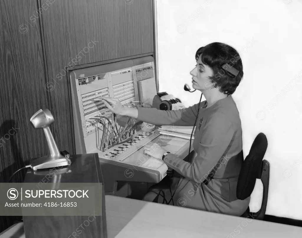 1960S Woman Office Telephone Switchboard Operator Wearing Headset Transferring Call Receptionist Answering Service Microphone