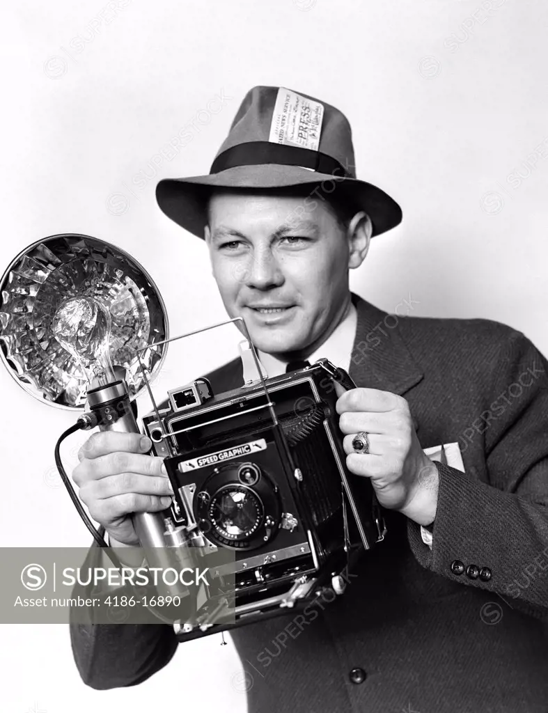 1930S 1940S 1950S Press Photographer Man Holding Speed Graphic Camera With Flash Bulb Illumination