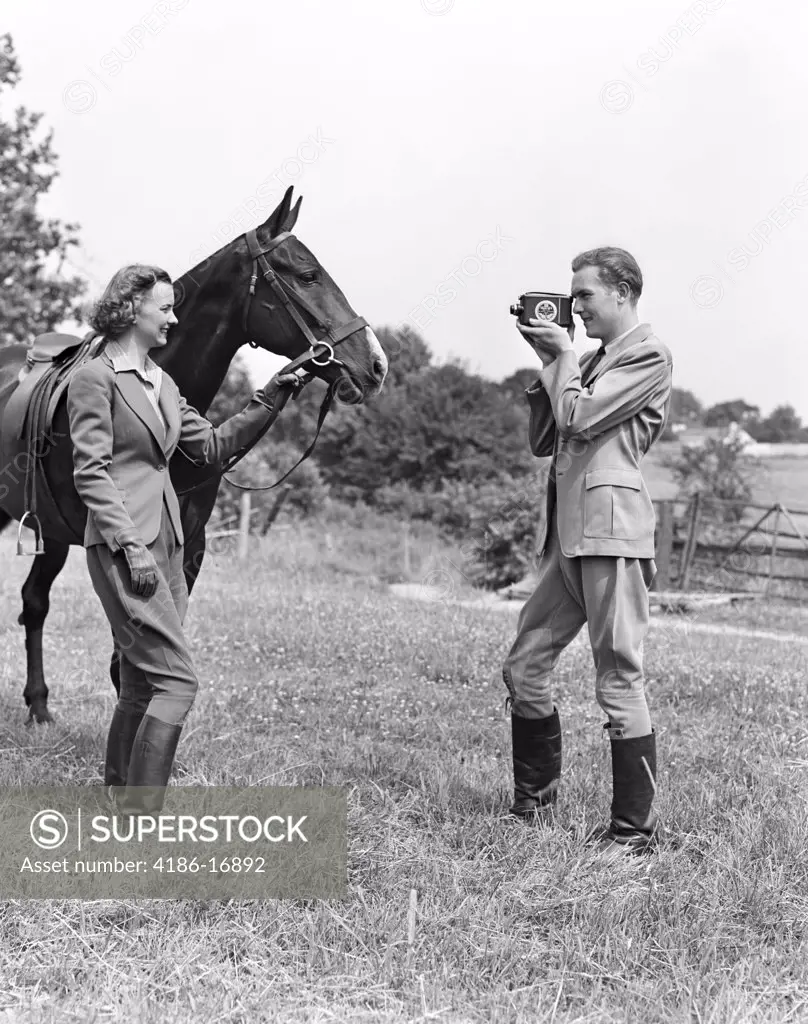1940S Smiling Equestrian Couple The Woman Is Holding The Horse Bridle While The Man Is Taking Home Movie