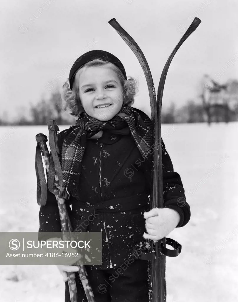 1930S Little Girl Standing Holding Skis And Poles Smiling
