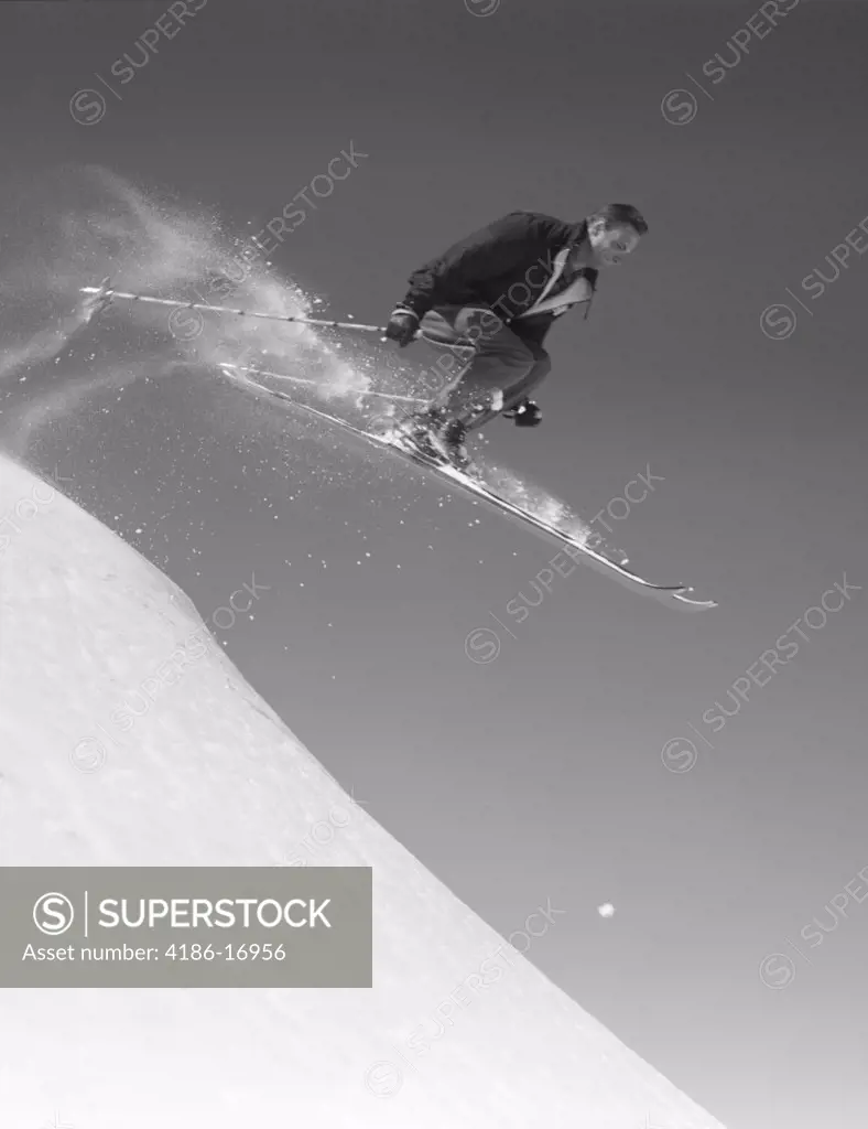 1950S Man Skiing Downhill Off Slope Jumping Into Air Ski Skis Sports Winter Snow