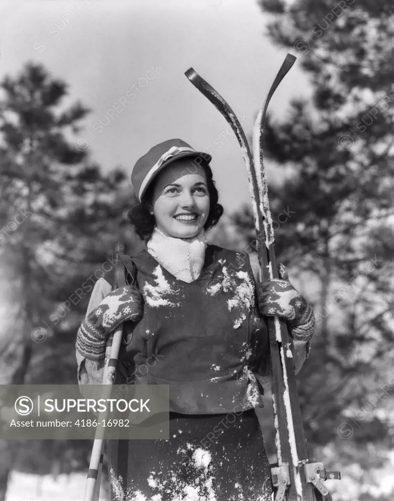1930S Smiling Woman Holding Skis Outside Covered In Snow