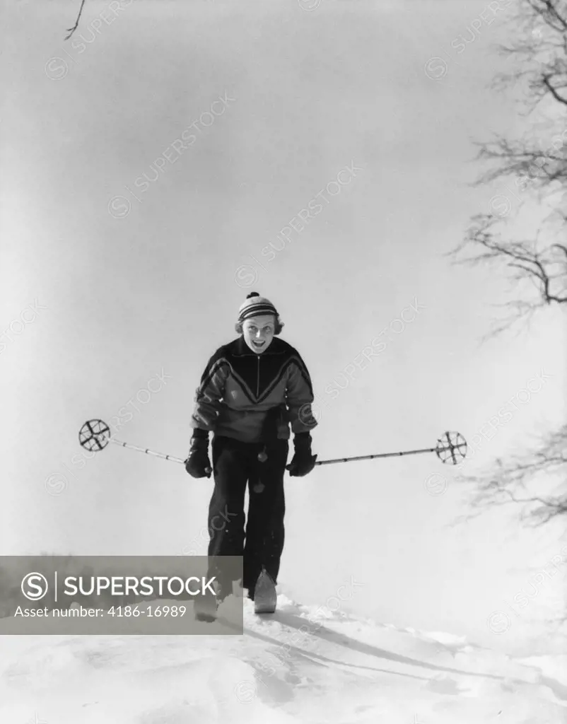 1930S Woman Holding Ski Poles Skiing In Snow