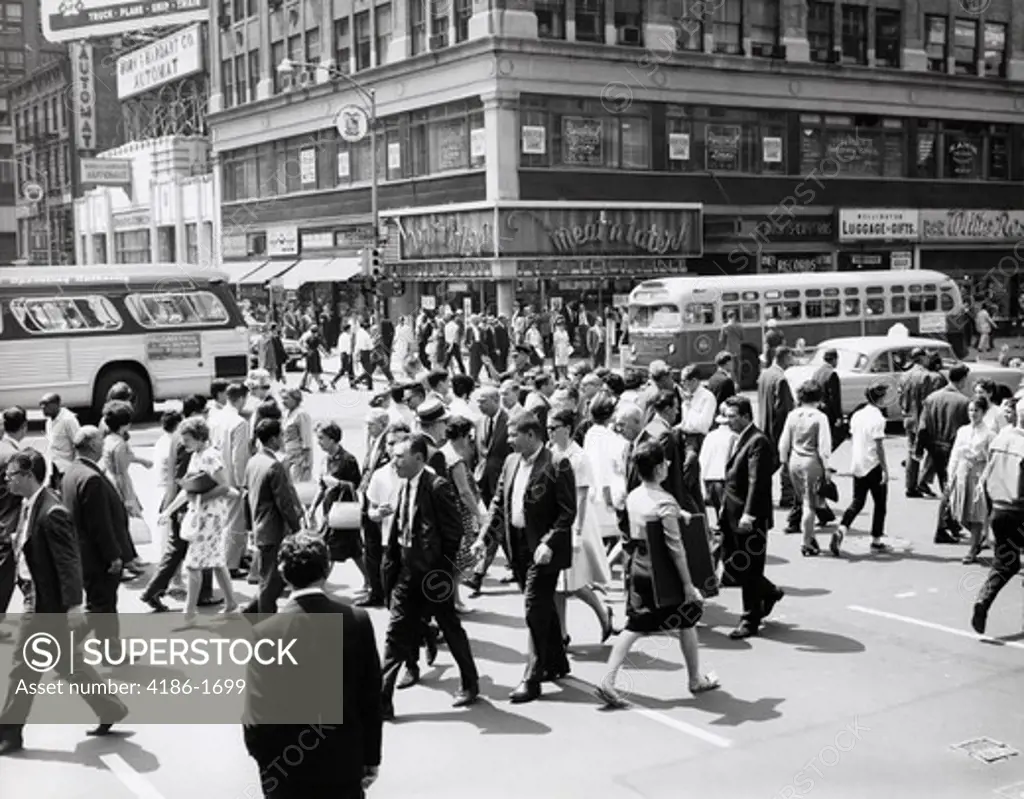 1960S Crowd Crossing Busy Intersection In New York City With Bus & Cab In Background