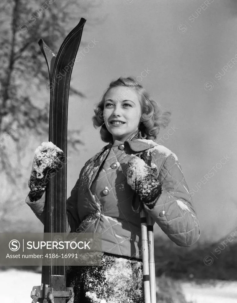 1930S Girl Standing Holding Skis And Poles Smiling