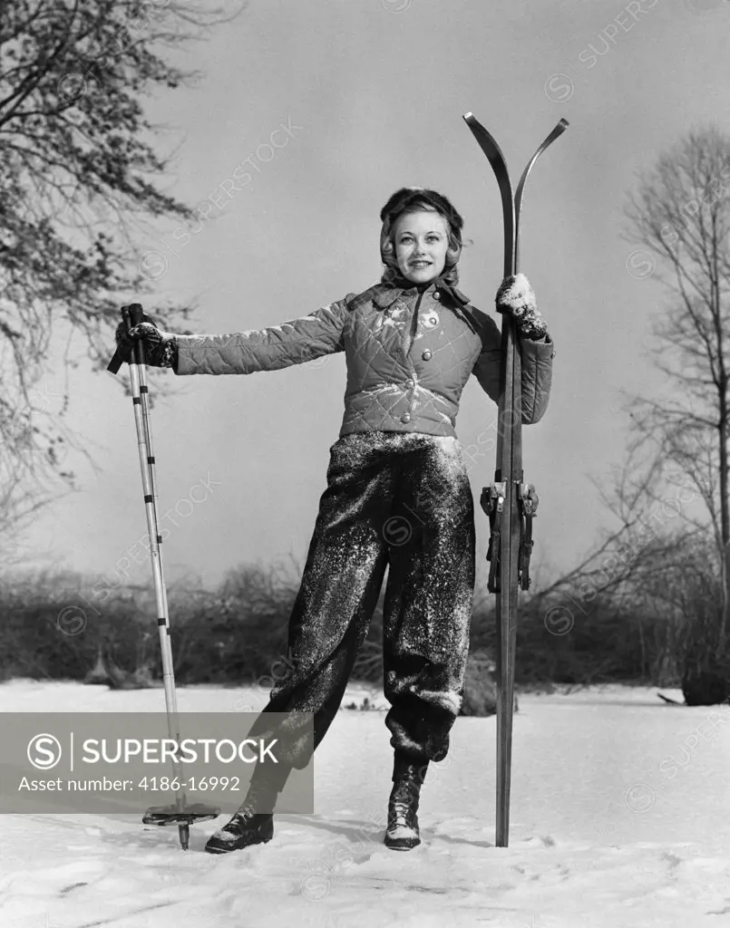1930S Girl Standing Holding Skis And Poles Smiling