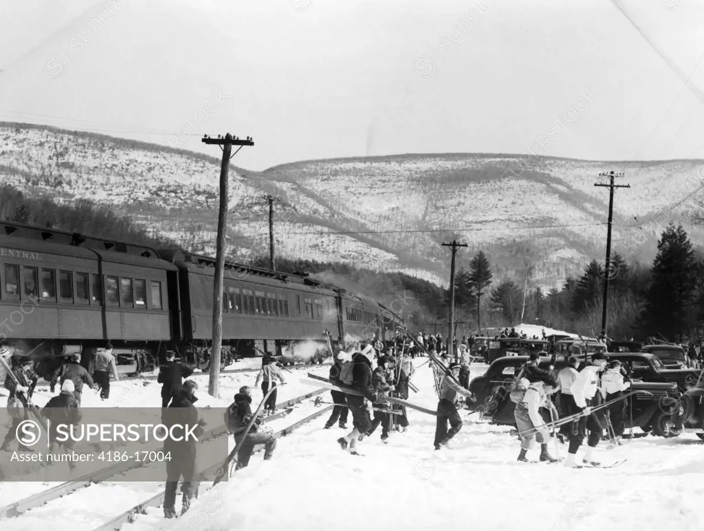 1940S Groups Of People Carrying Skiing Equipment By Passenger Train Tracks Ski Resort Bear Mountain New York Usa