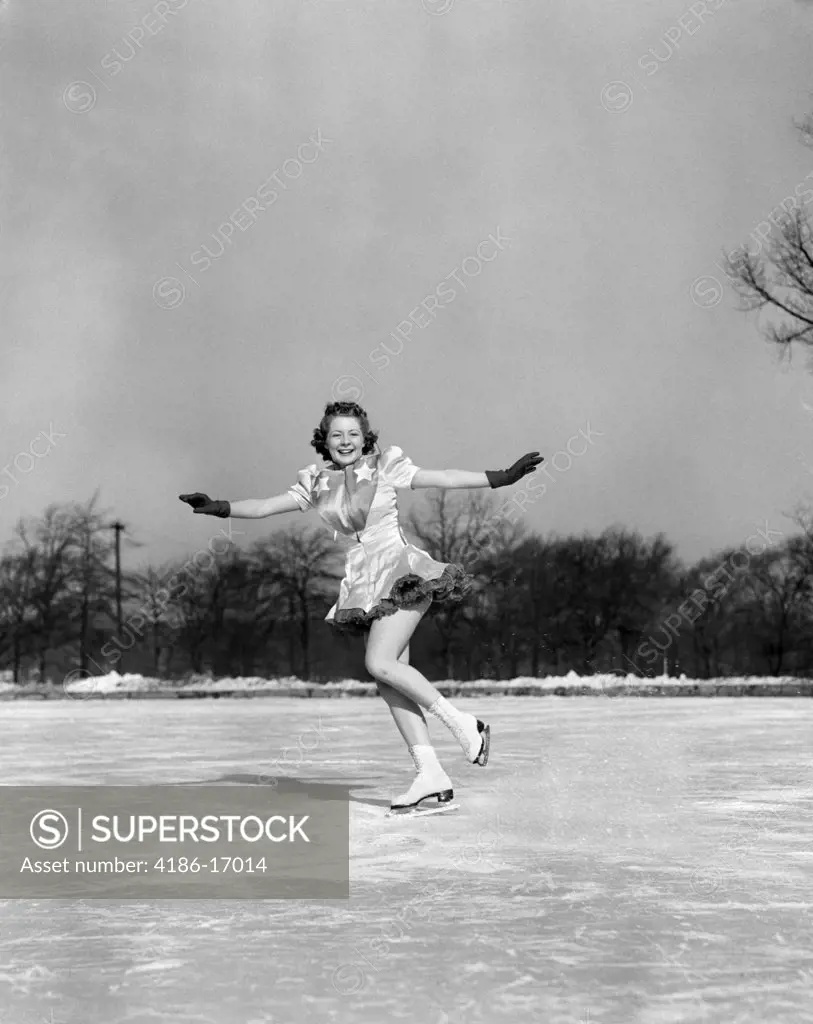1940S Smiling Woman On Ice Outdoors Ice Skating Arms Out About To Do Backward Jump