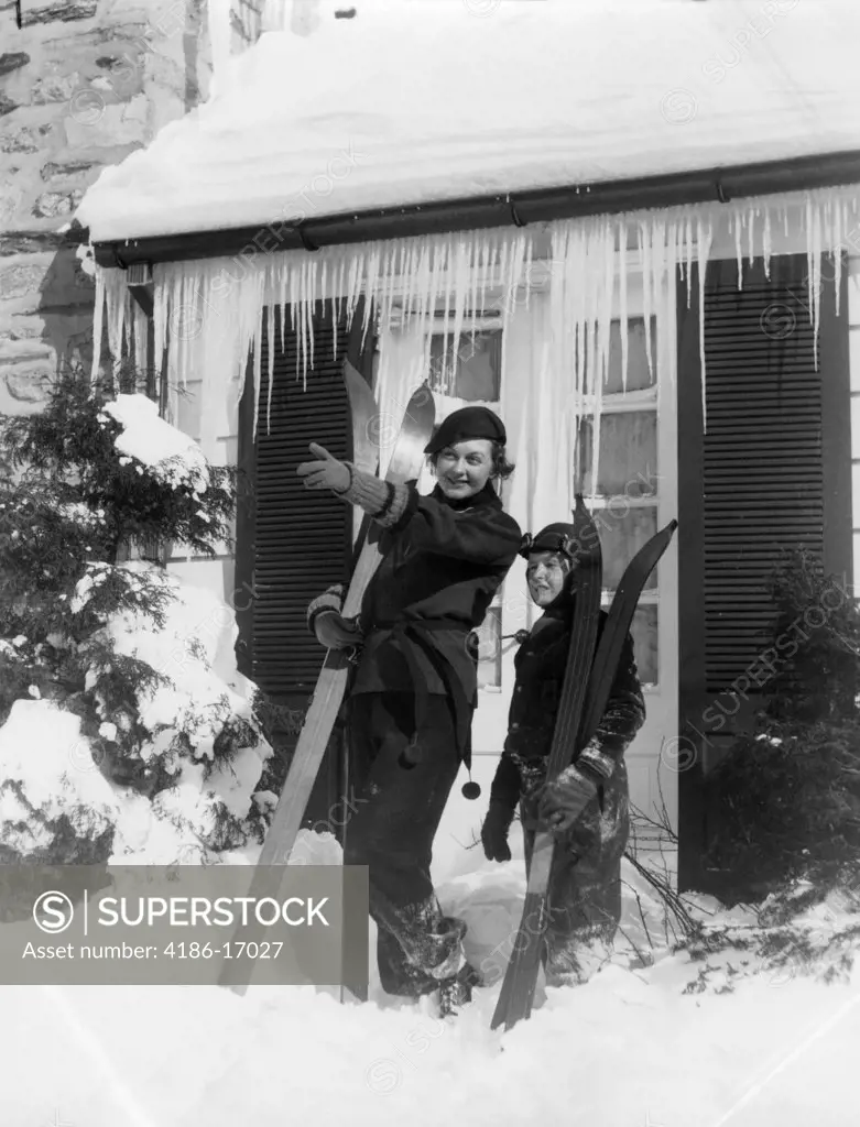 1930S Mother Son Standing Holding Skis In Front Of Winter House With Icicles