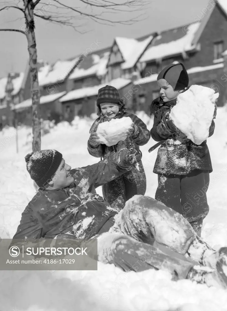 1930S 1940S Man Father Two Children Playing In Winter Snow