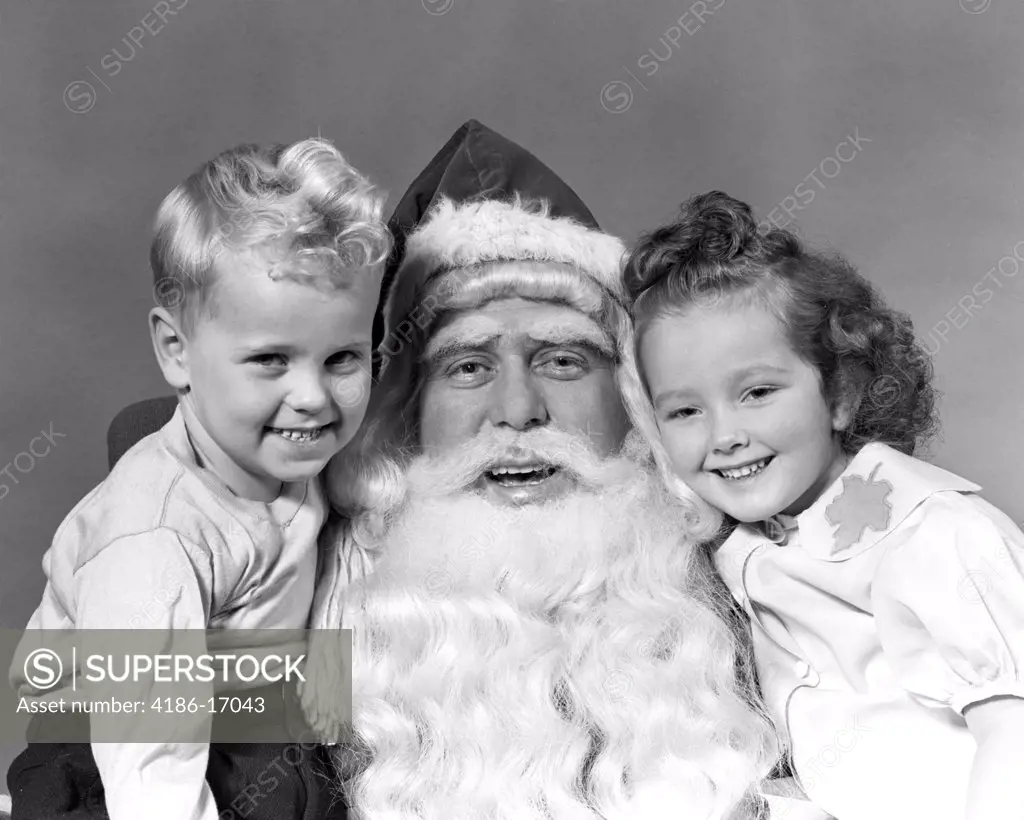 1940S Man Santa Claus Posing With Young Boy And Girl In Lap Smiling Indoor