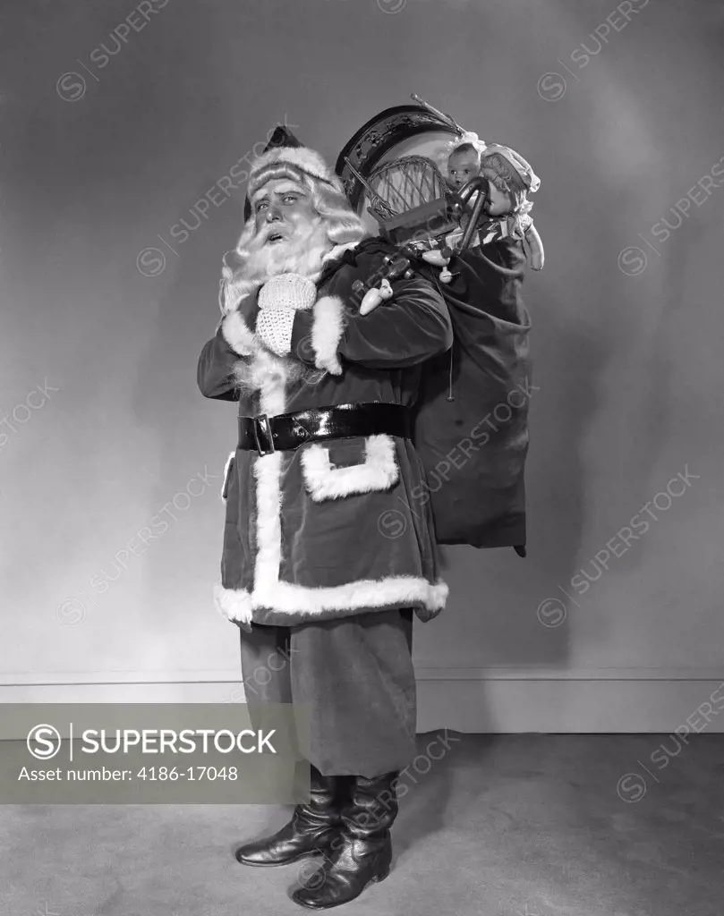 1940S Santa Claus Carrying Bag Full Of Toys On His Back