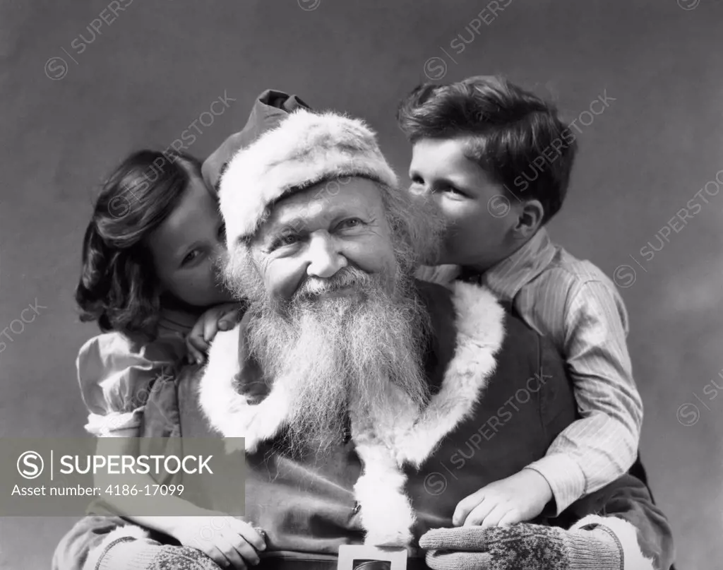 1930S Man Smiling Santa Claus Posing With Boy And Girl Whispering In His Ears