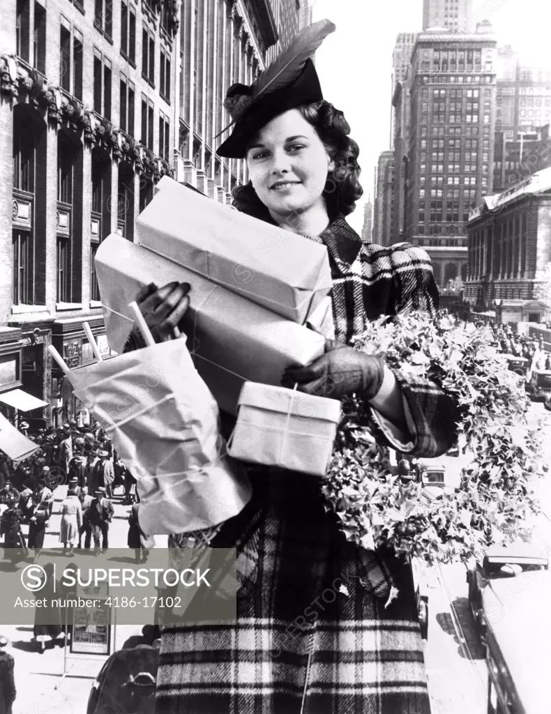 1930S 1940S Woman Arms Full With Christmas Shopping Packages & Wreath Composite With City Street Scene