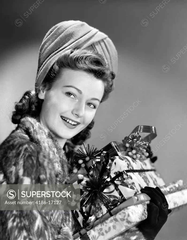 1940S Woman In Fur Coat Holding Stack Of Christmas Presents