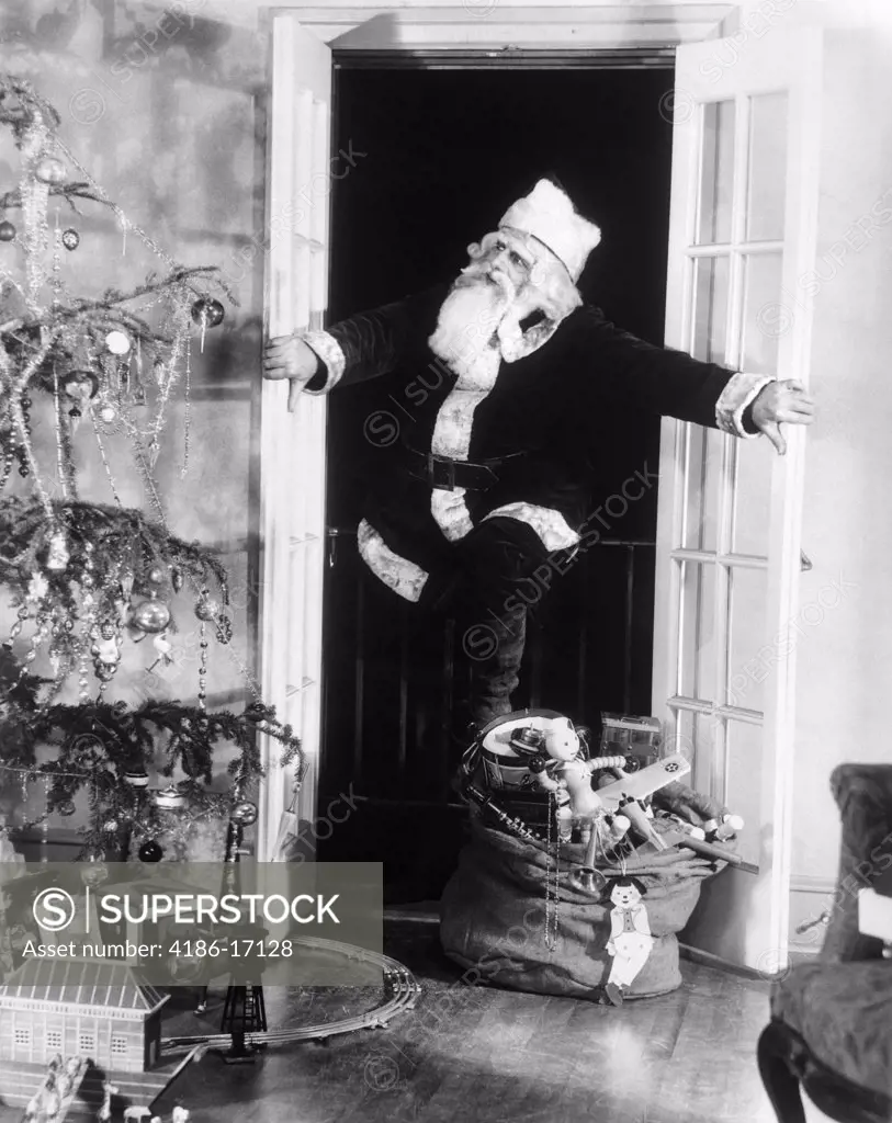 1920S1930S Santa Claus Sneaking Into Living Room Through Double Doors