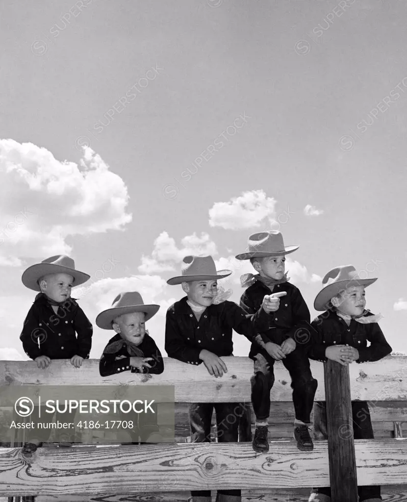 1950S Five Boys Brothers Dressed As Cowboys Sitting Together On Corral Fence