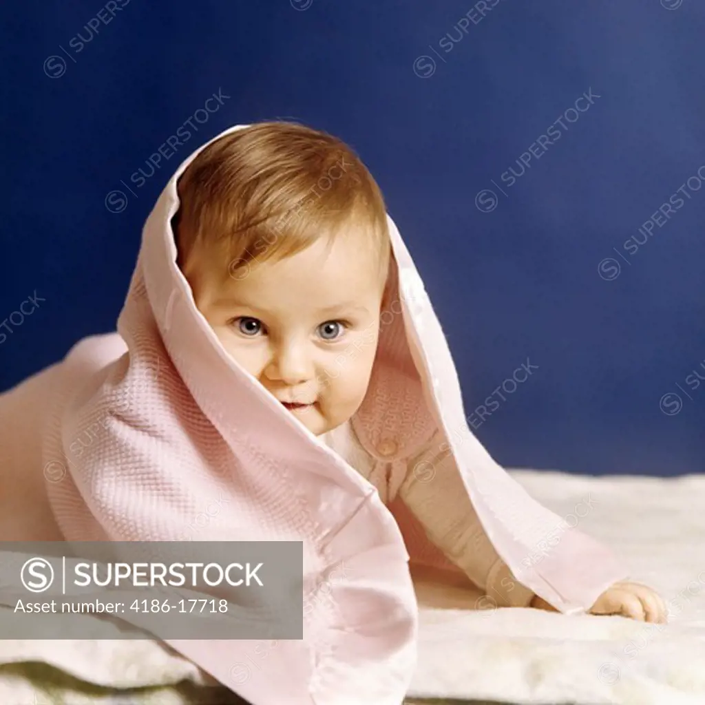1980S Baby Girl Peeking Out From Under Blanket Blue Eyes Looking At Camera