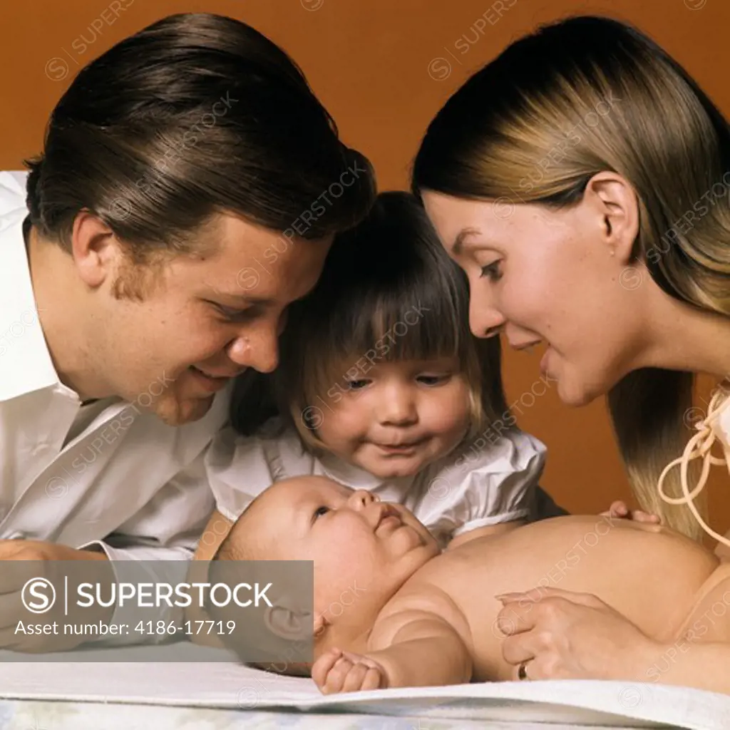 1960S Family Looking At New Baby Mother Father Sister