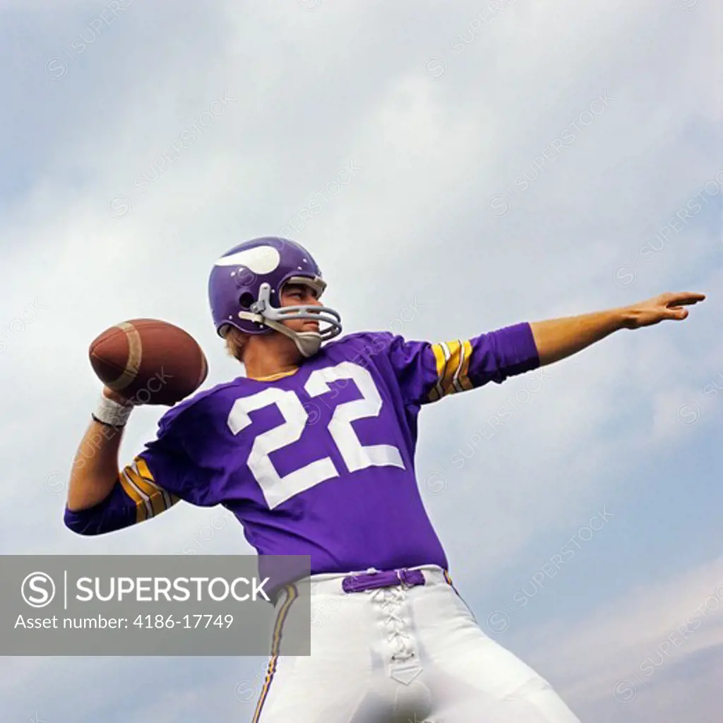 1970S American Football Player Purple Jersey 22 About To Throw The Ball