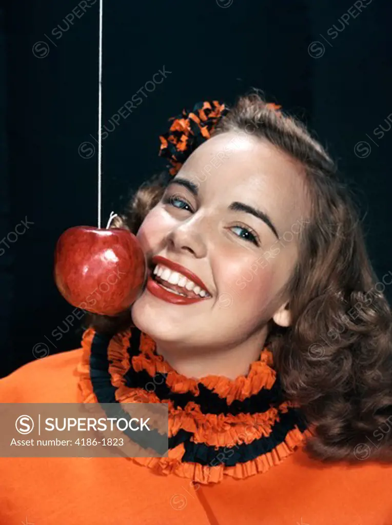 1940S 1950S Smiling Young Woman Wearing Halloween Costume Bobbing For Apple On A String