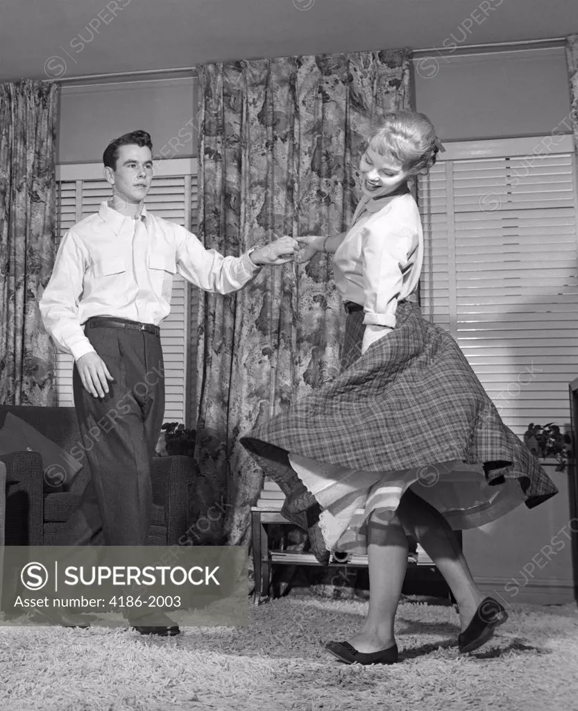 1950S Teen Couple Doing The Jitterbug In Living-Room