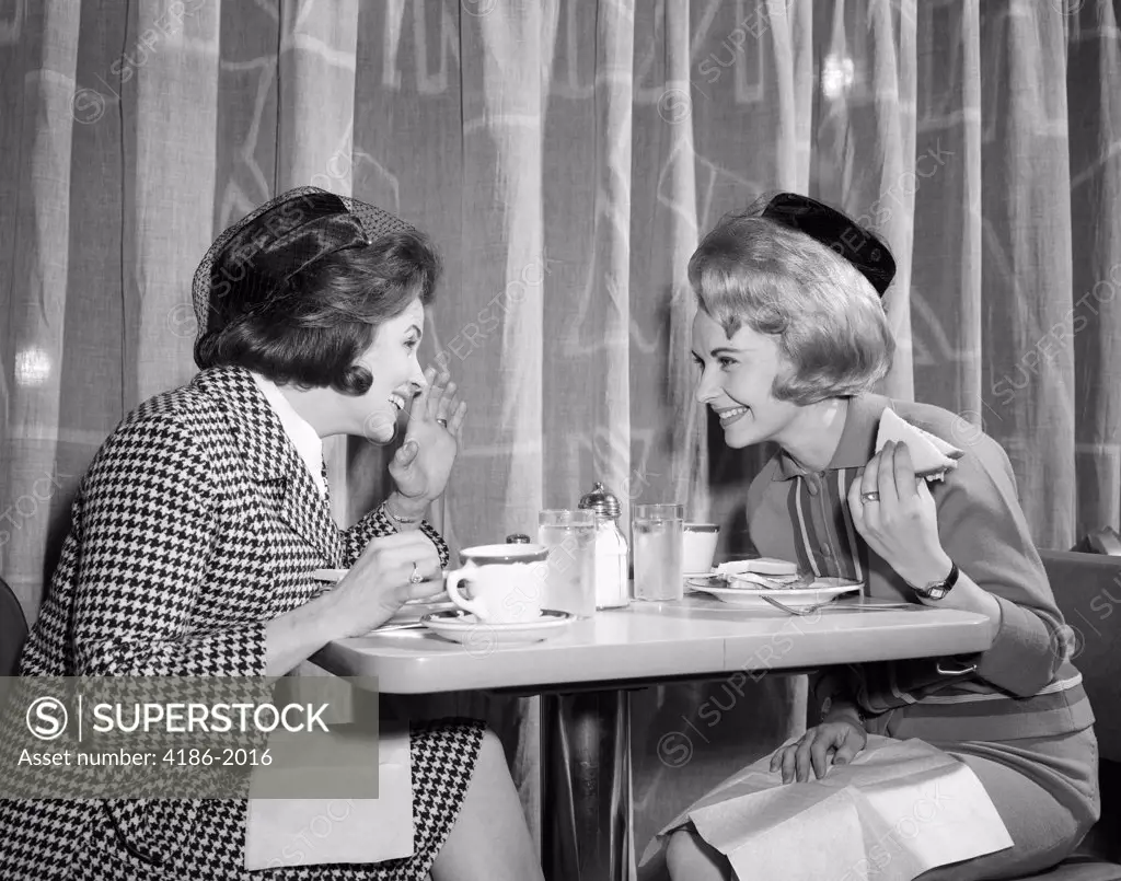1960S Women Gossiping At Lunch In Restaurant