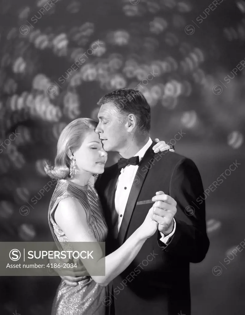 1960S Couple Woman In Evening Dress And Man In Tuxedo Slow Dancing