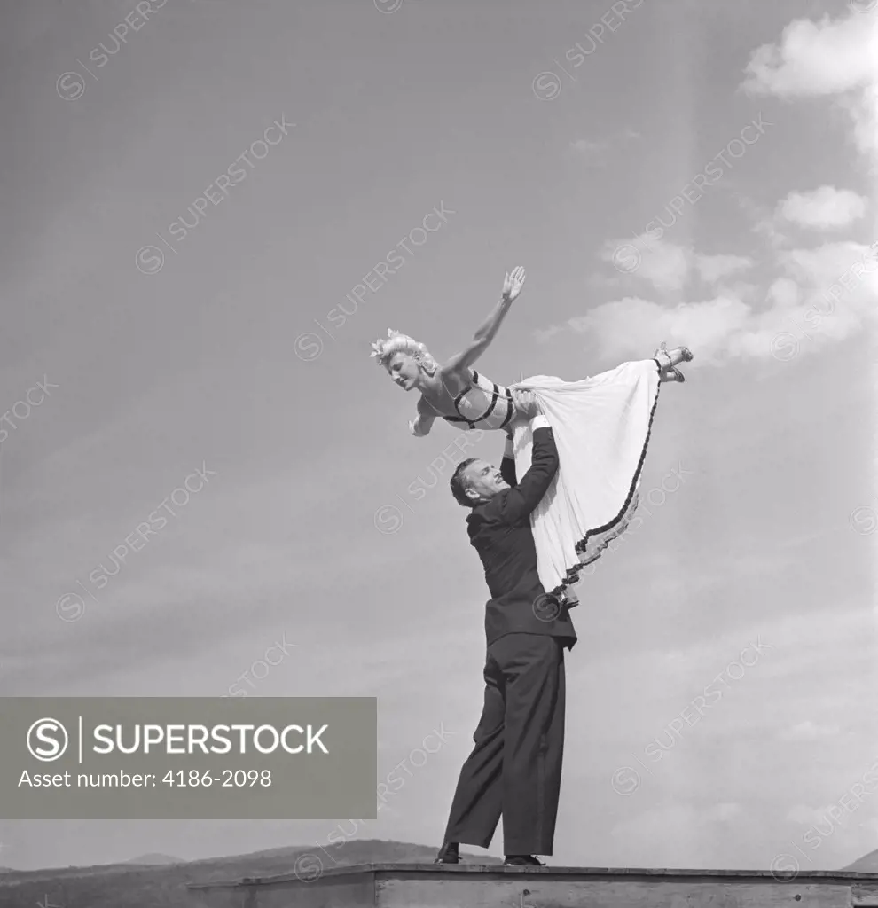 1940S Ballroom Dancing Couple Man Lifting Woman Into The Air