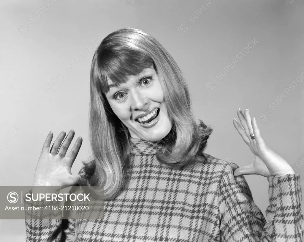 1960s WOMAN WITH GOOFY SURPRISED LOOK ON FACE AND HANDS IN THE AIR SMILING LOOKING AT CAMERA
