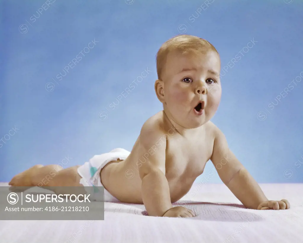 1960s BABY WITH FUNNY FACIAL EXPRESSION DOING PUSHUP