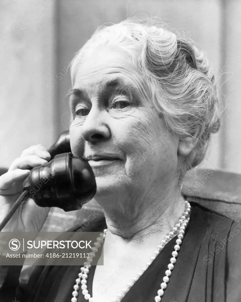 1930s 1940s OLD WOMAN ON TELEPHONE HEAD AND SHOULDERS GRAY HAIR PEARLS LOOKING AT CAMERA