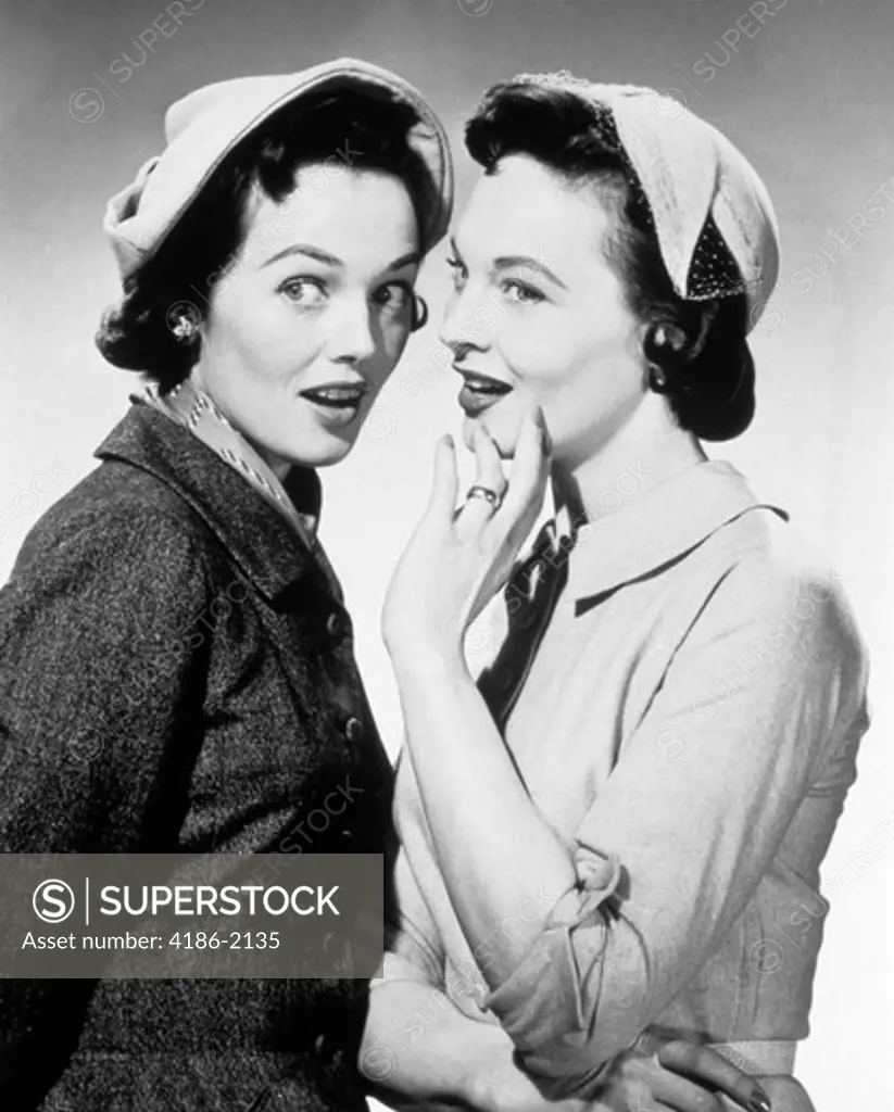 1950S Two Women Wearing Hats Whispering Gossip