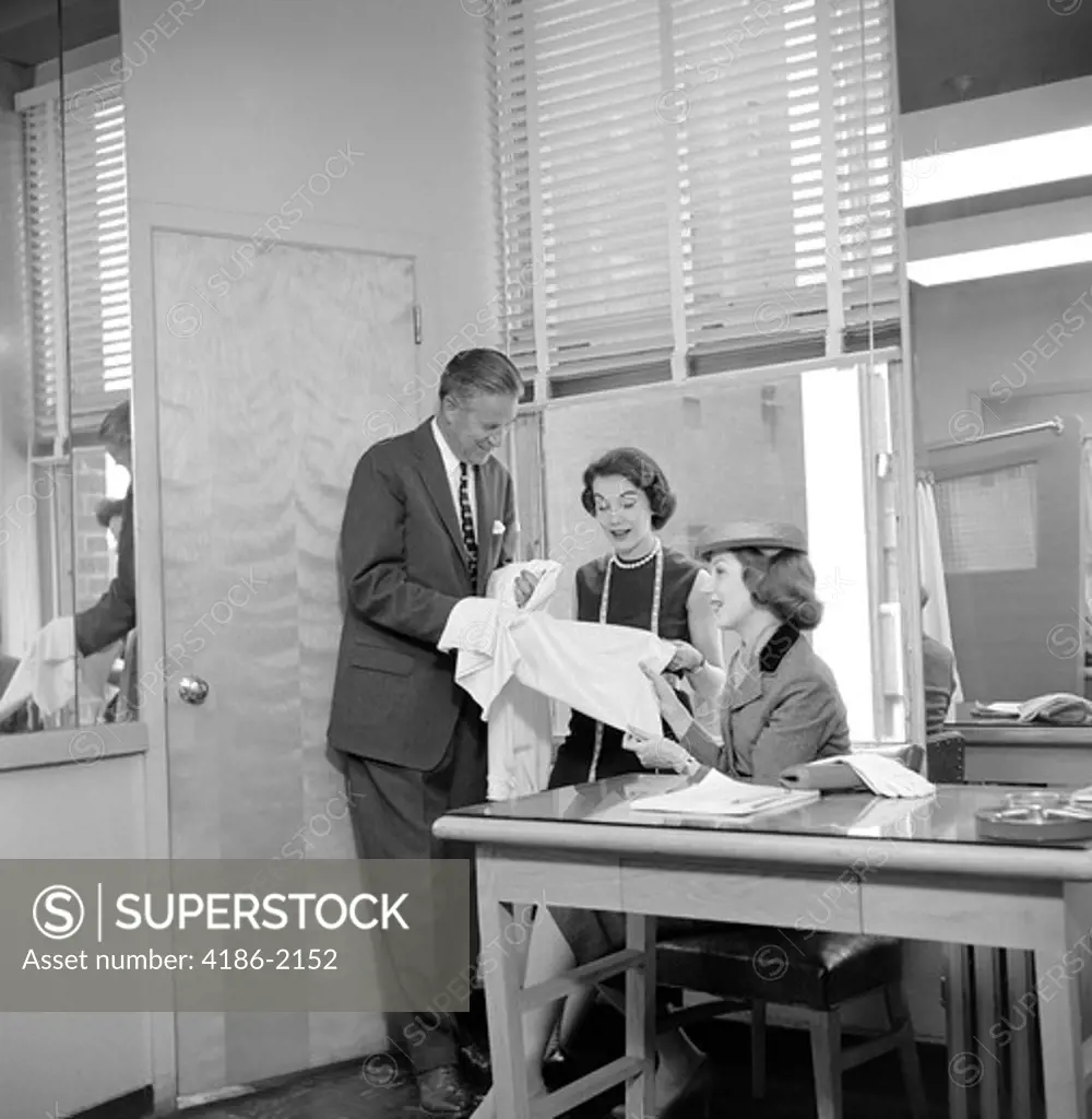1950S Female Fashion Buyer Selecting Fabric In Garment Industry Showroom