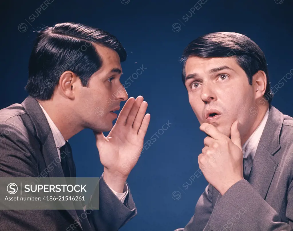 1960s DOUBLE EXPOSURE PORTRAIT OF MAN WHISPERING INFORMATION TO HIMSELF