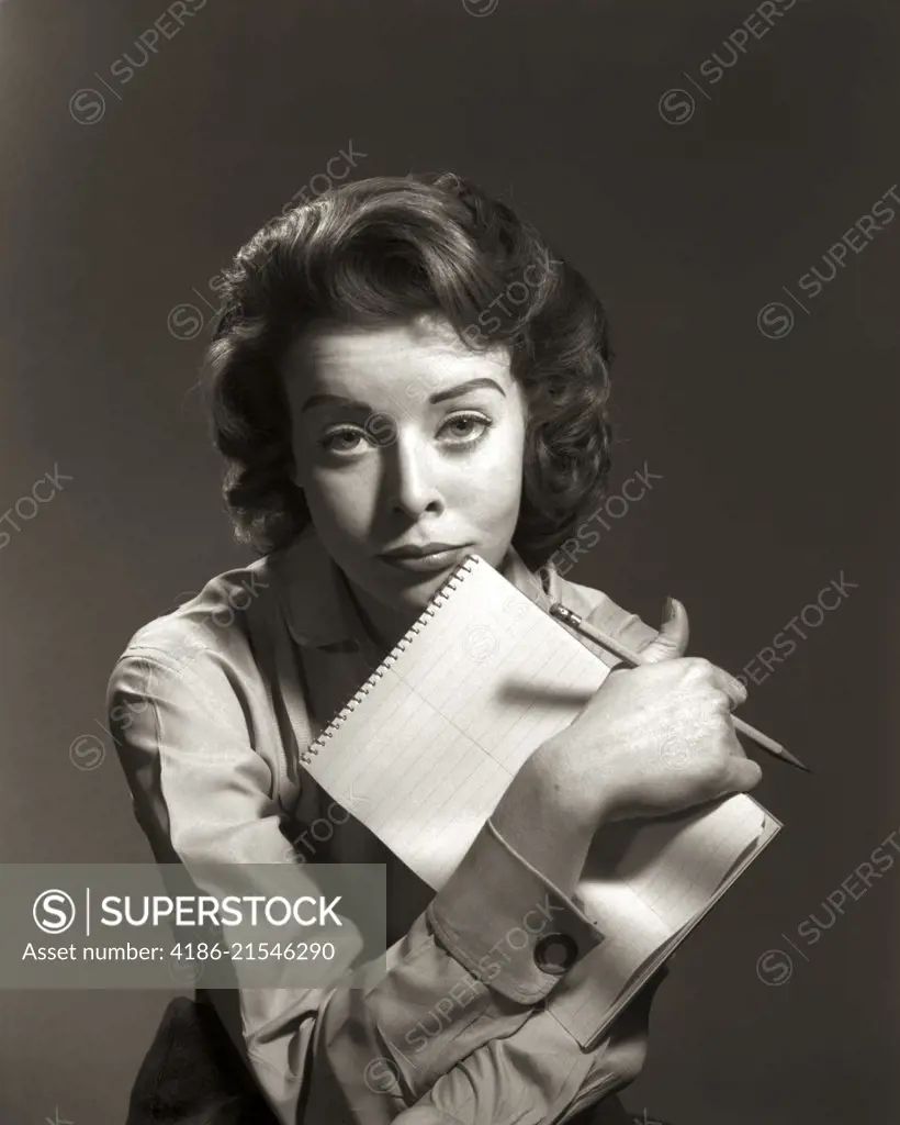 1950s 1960s OVERWORKED WOMAN SECRETARY STENOGRAPHER OFFICE WORKER LEANING CHIN ON STENO PAD AND PENCIL LOOKING AT CAMERA