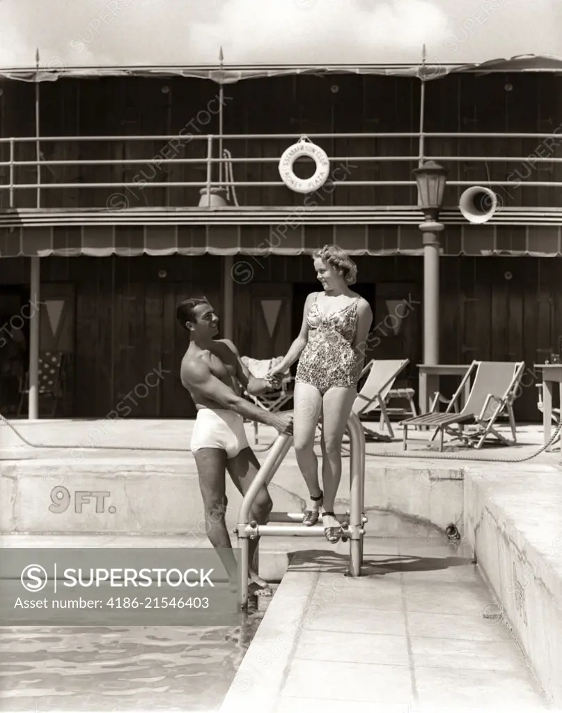 1930s MAN WOMAN COUPLE IN BATHING SUITS POOL SIDE VACATION HOTEL MIAMI BEACH FLORIDA USA