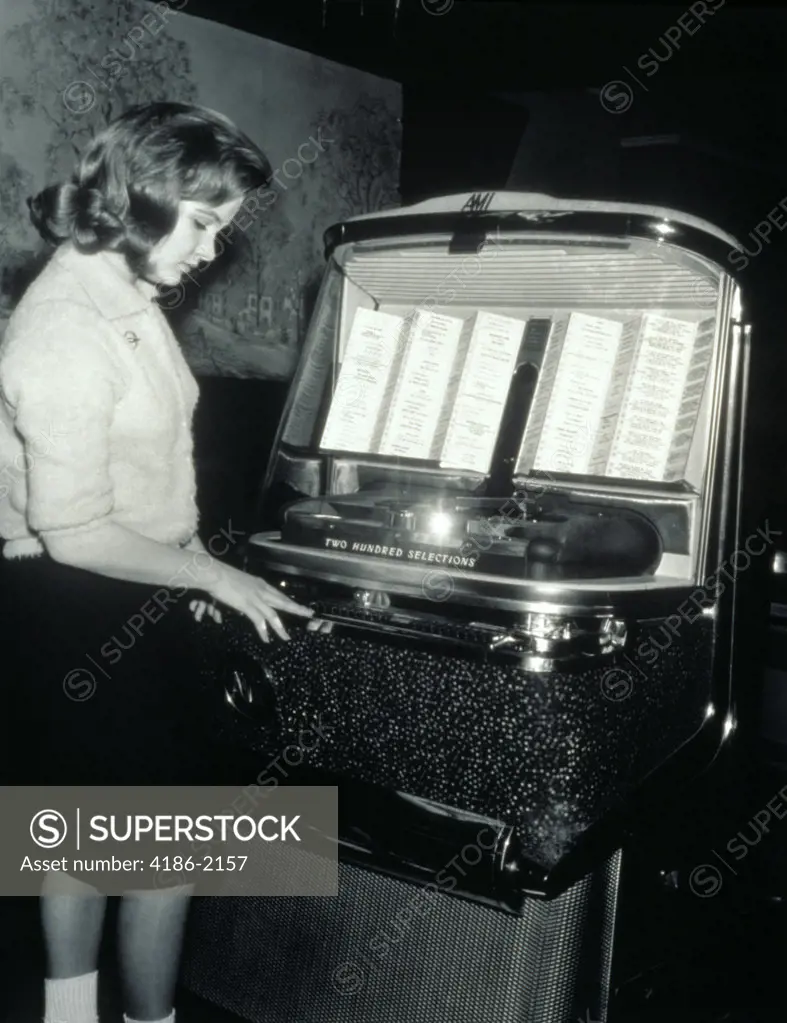 1950S Teenage Girl Selecting Music On Jukebox